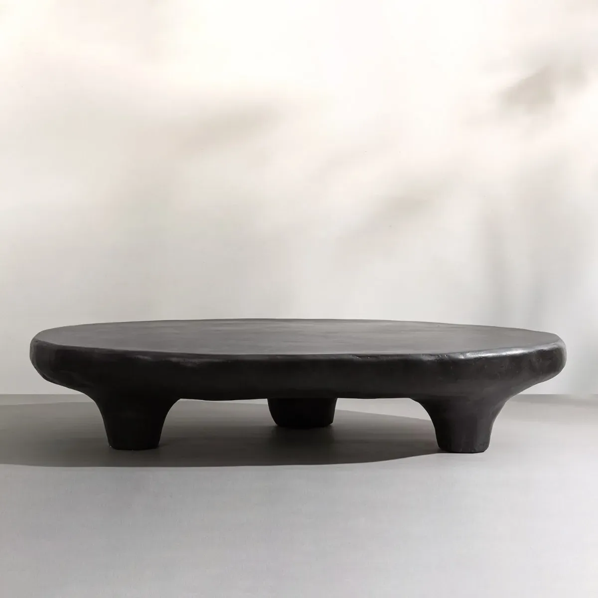 Isla Organic Shaped Tripod Low Coffee Table - Black, Concrete product