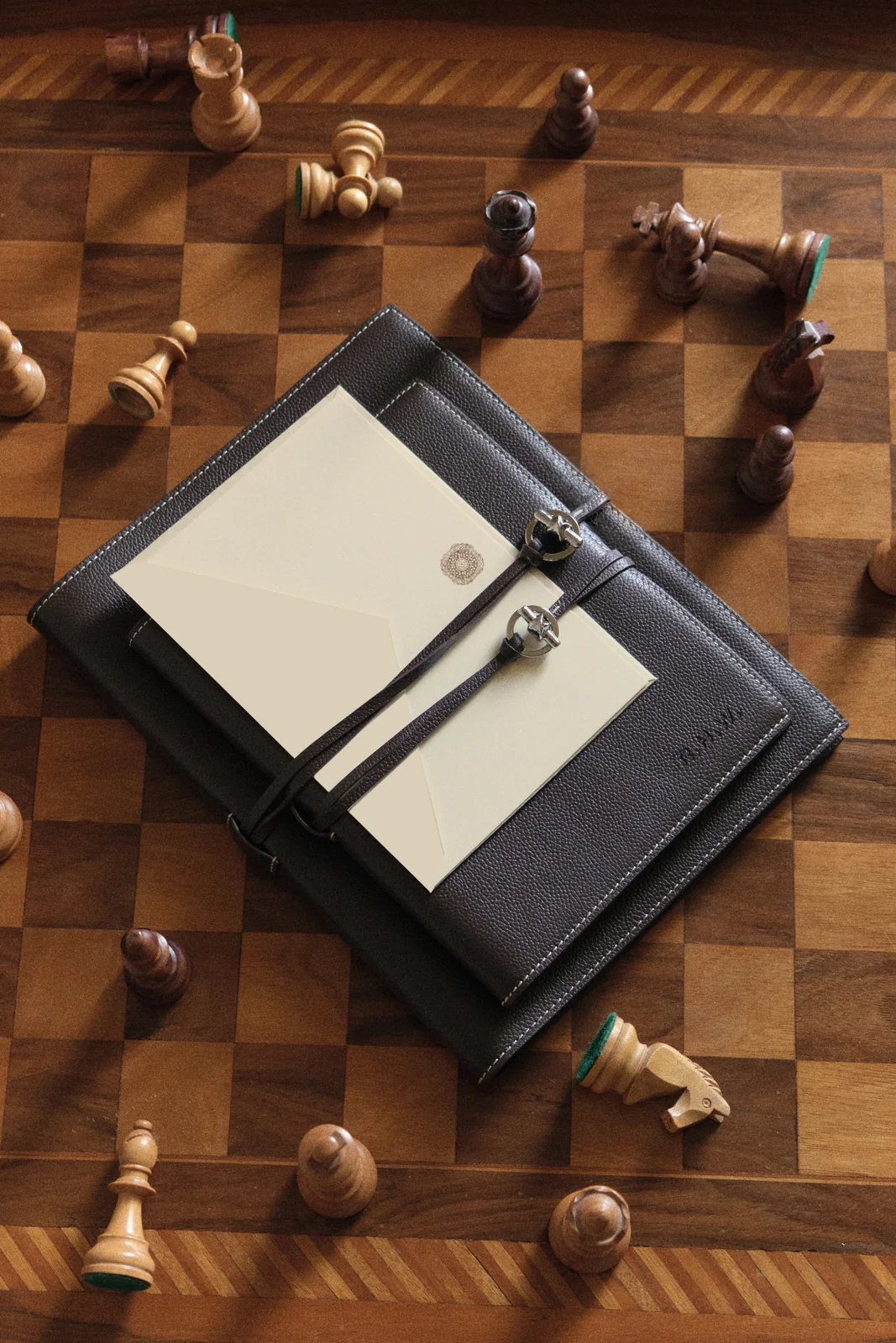 Campaign imagery from Rosie Huntington-Whiteley’s luxury gifting brand Mémoire featuring personalised leather journals, candlelit tablescapes and quiet luxury interiors.