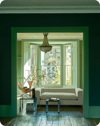 A Farrow & Ball painted sitting room in a deep muted green