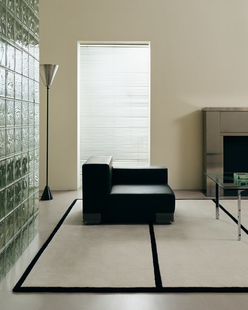 A large wool rug anchoring a sitting room