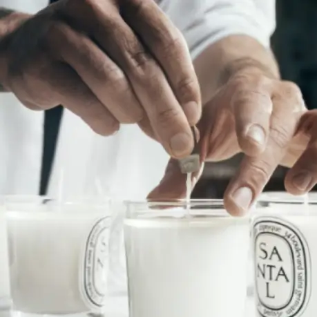 The wick of each candle is straightened by hand